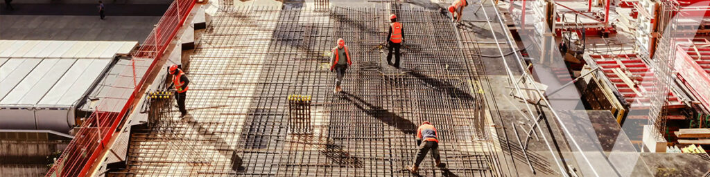 Construction workers spreading concrete