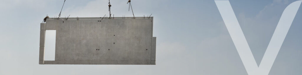 A crane carrying a precast concrete wall